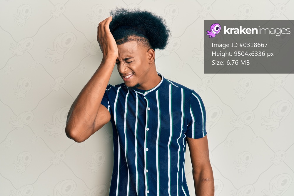 African american man with afro hair wearing casual clothes surprised with hand on head for mistake, remember error. forgot, bad memory concept. 