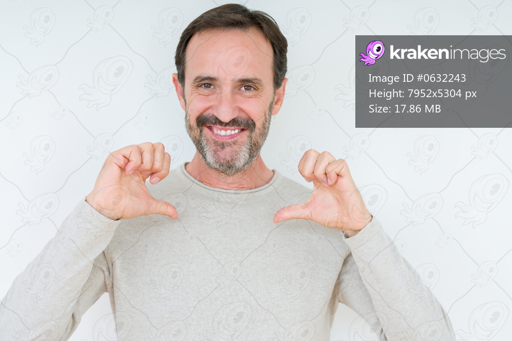 Elegant senior man over isolated background looking confident with smile on face, pointing oneself with fingers proud and happy.