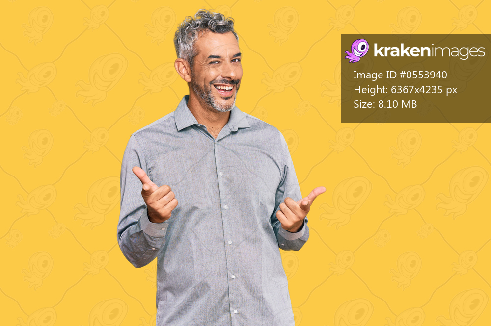 Middle age grey-haired man wearing casual clothes pointing fingers to camera with happy and funny face. good energy and vibes. 