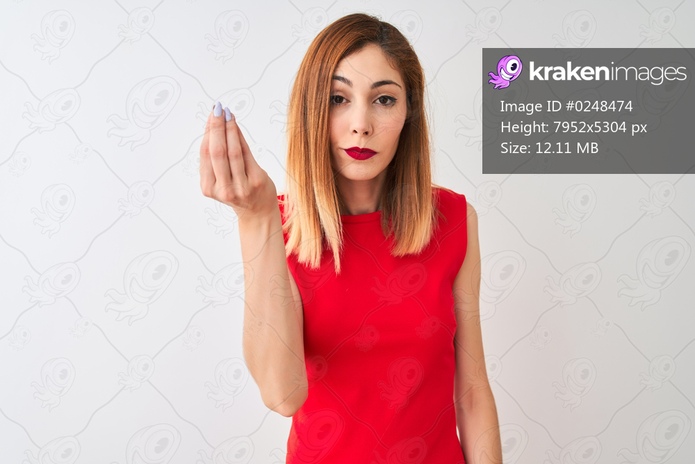 Redhead businesswoman wearing elegant red dress standing over isolated white background Doing Italian gesture with hand and fingers confident expression