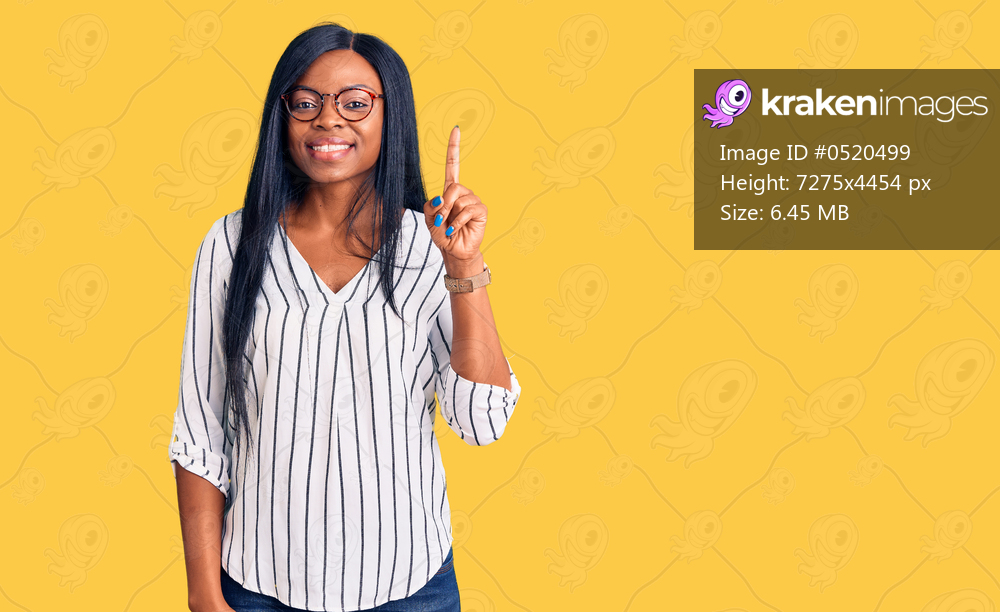 Young african american woman wearing casual clothes and glasses pointing finger up with successful idea. exited and happy. number one. 