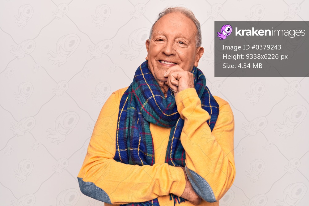 Senior handsome grey-haired man wearing casual scarf over isolated white background smiling looking confident at the camera with crossed arms and hand on chin. Thinking positive.