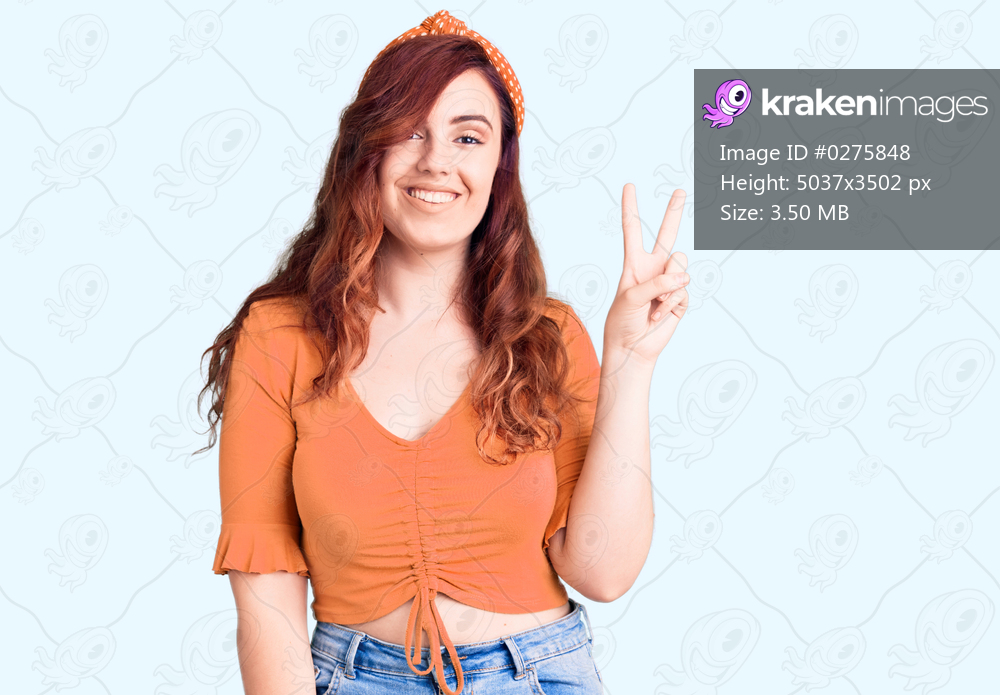Young beautiful woman wearing casual clothes smiling with happy face winking at the camera doing victory sign. number two. 