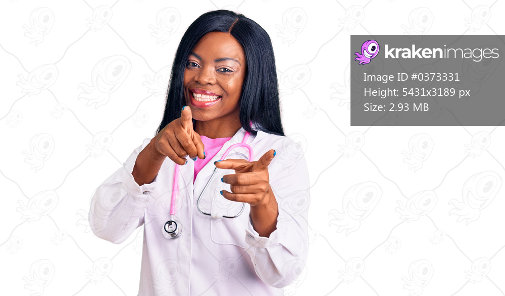 Young african american woman wearing doctor stethoscope pointing fingers to camera with happy and funny face. good energy and vibes. 