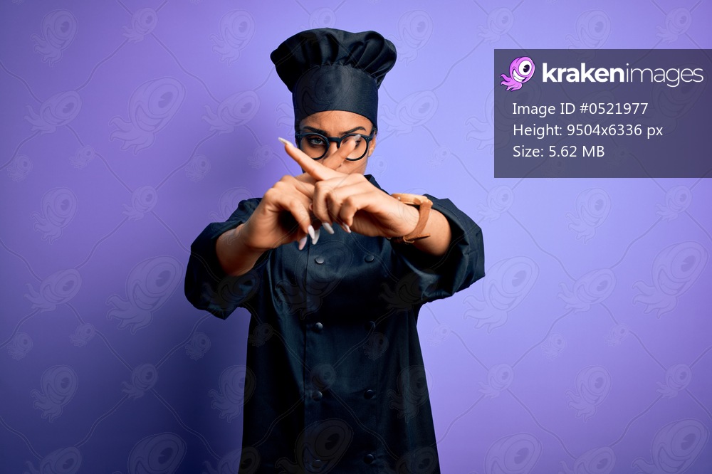 Young african american chef girl wearing cooker uniform and hat over purple background Rejection expression crossing fingers doing negative sign