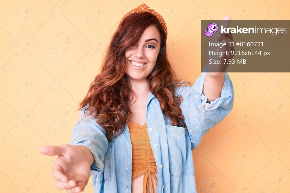 Young beautiful woman wearing casual clothes looking at the camera smiling with open arms for hug. cheerful expression embracing happiness. 