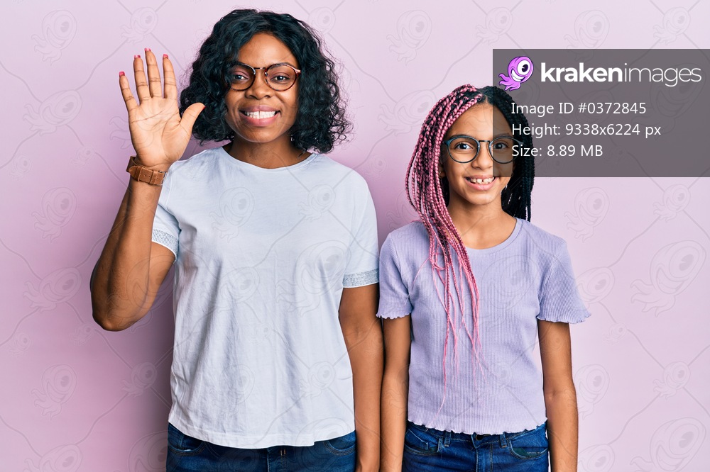 Beautiful african american mother and daughter wearing casual clothes and glasses showing and pointing up with fingers number five while smiling confident and happy. 