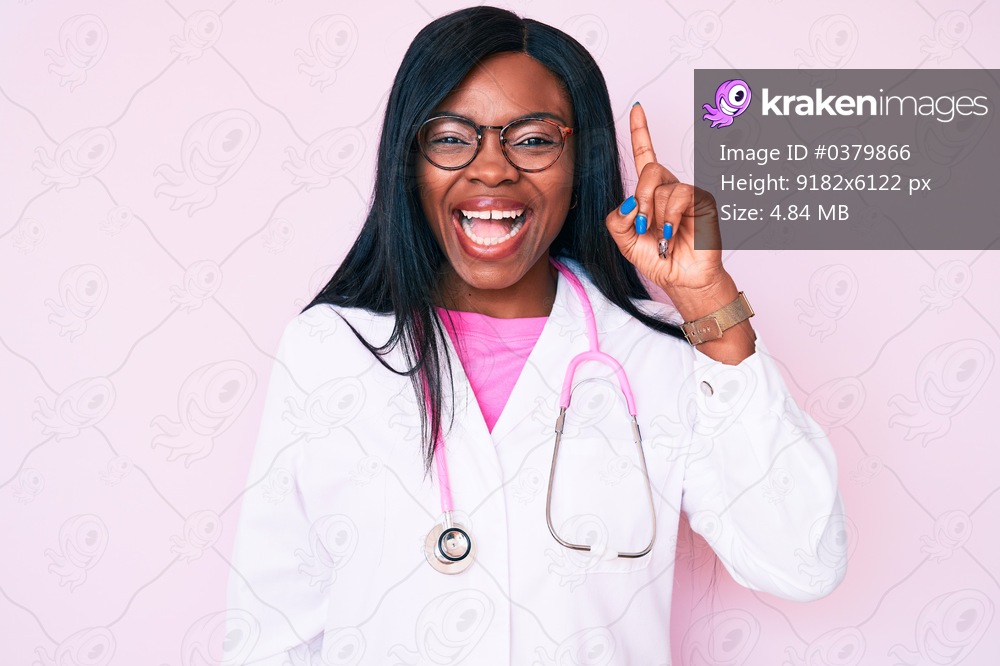 Young african american woman wearing doctor stethoscope pointing finger up with successful idea. exited and happy. number one. 