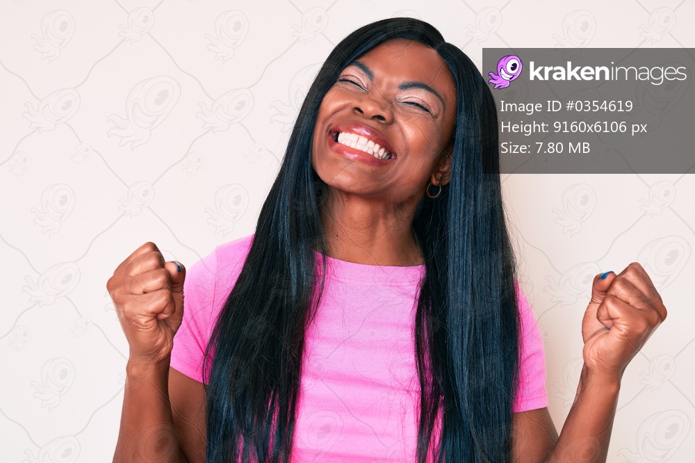 Young african american woman wearing casual clothes very happy and excited doing winner gesture with arms raised, smiling and screaming for success. celebration concept. 