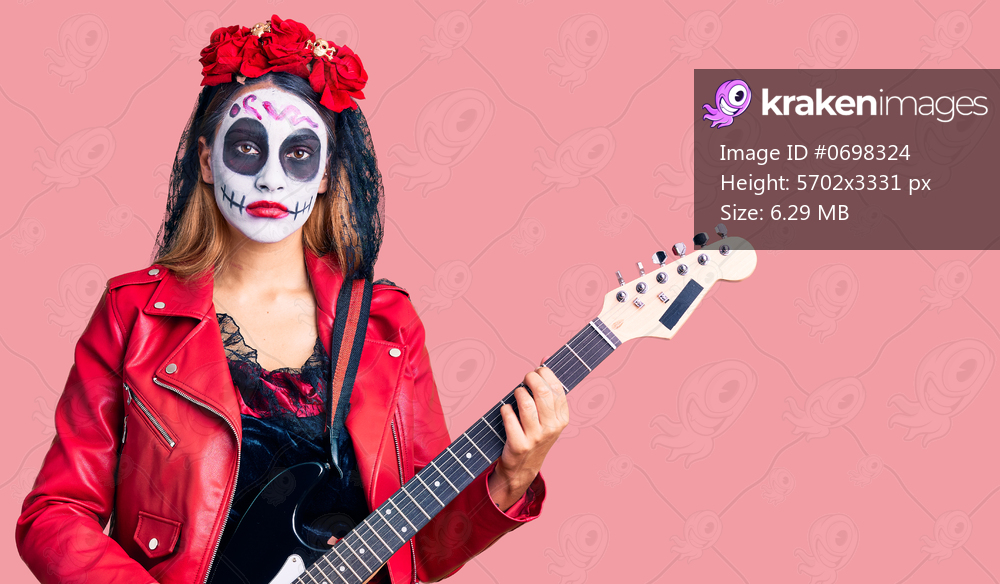 Woman wearing day of the dead costume playing electric guitar thinking attitude and sober expression looking self confident 