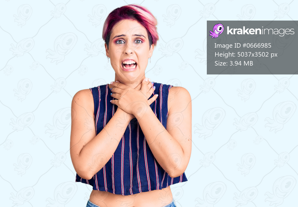 Young beautiful woman with pink hair wearing casual clothes shouting and suffocate because painful strangle. health problem. asphyxiate and suicide concept. 