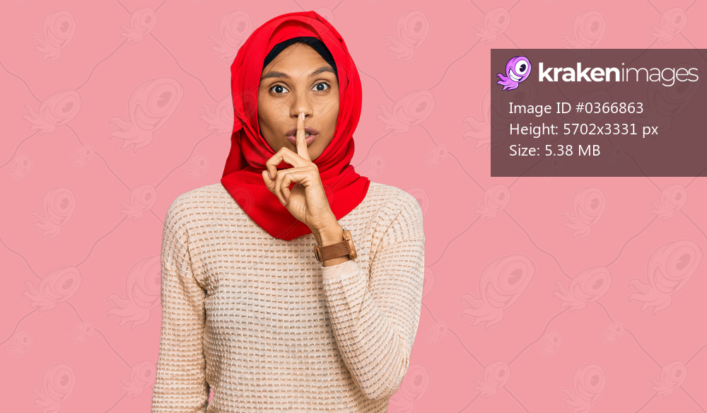 Young african american woman wearing traditional islamic hijab scarf asking to be quiet with finger on lips. silence and secret concept. 