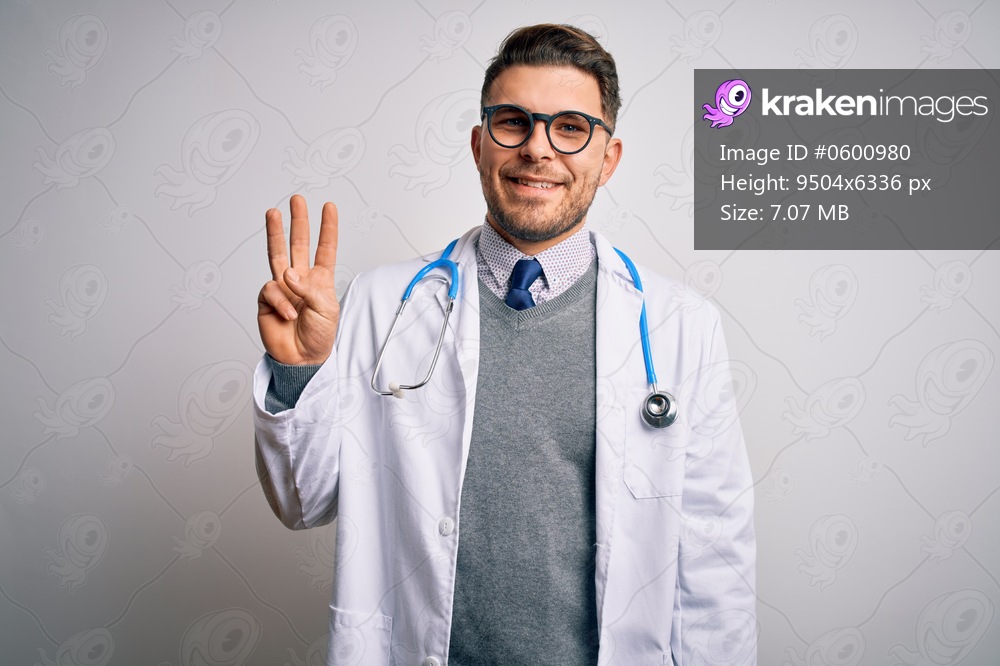 Young doctor man with blue eyes wearing medical coat and stethoscope over isolated background showing and pointing up with fingers number three while smiling confident and happy.