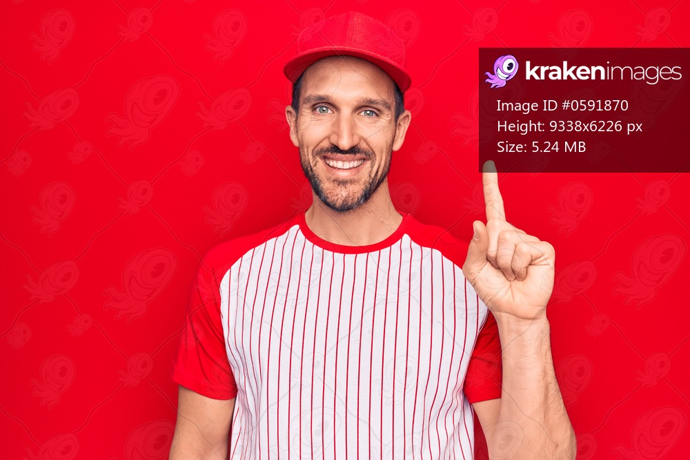 Young handsome player man wearing baseball sportswear over isolated red background smiling with an idea or question pointing finger up with happy face, number one