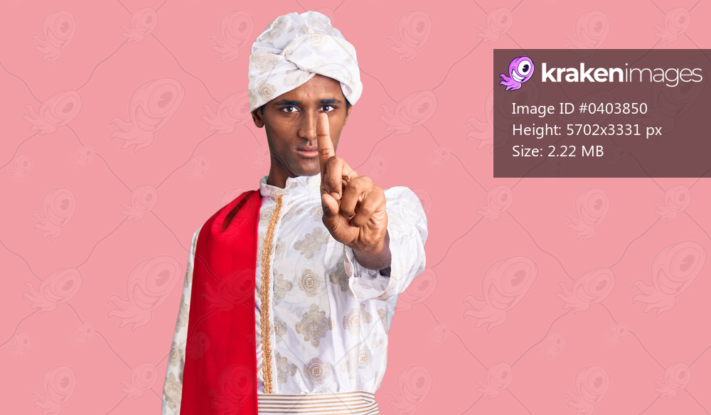 African handsome man wearing tradition sherwani saree clothes pointing with finger up and angry expression, showing no gesture 