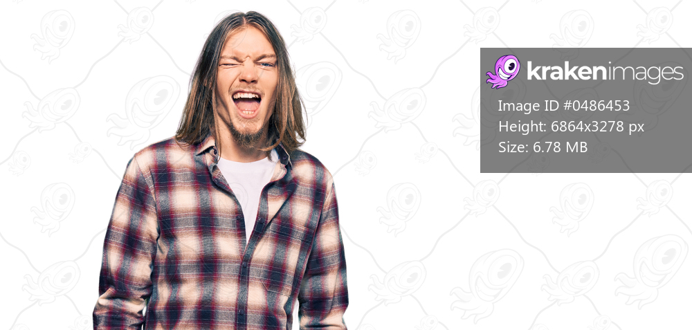 Handsome caucasian man with long hair wearing hipster shirt winking looking at the camera with sexy expression, cheerful and happy face. 