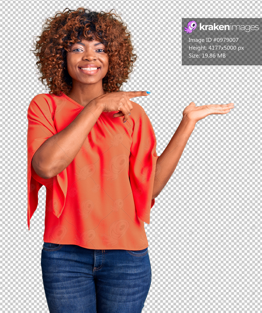 Young african american woman wearing casual clothes amazed and smiling to the camera while presenting with hand and pointing with finger.