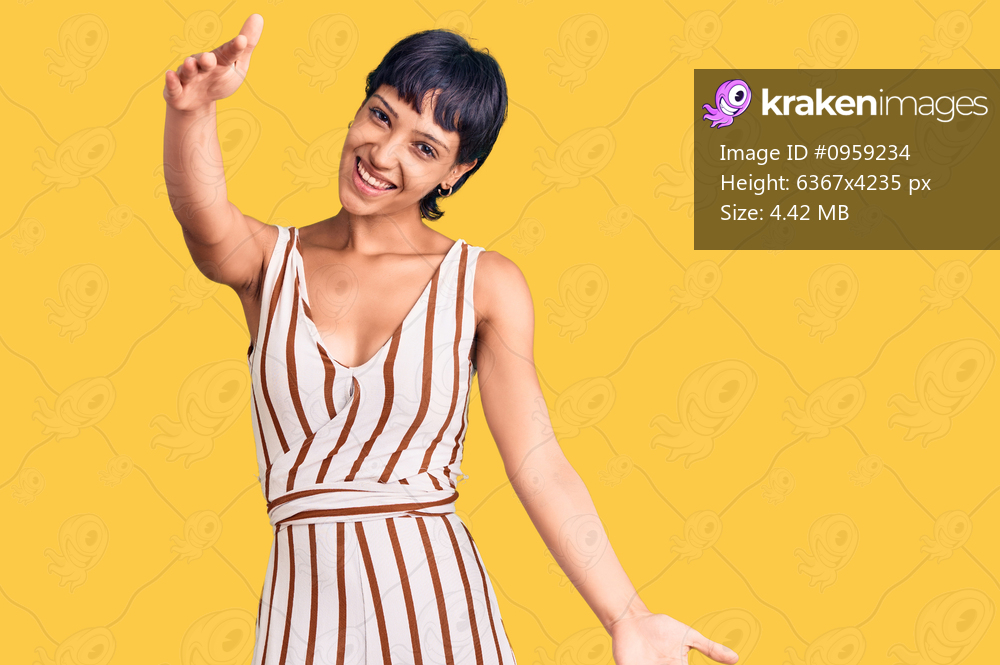 Young brunette woman with short hair wearing summer outfit looking at the camera smiling with open arms for hug. cheerful expression embracing happiness. 
