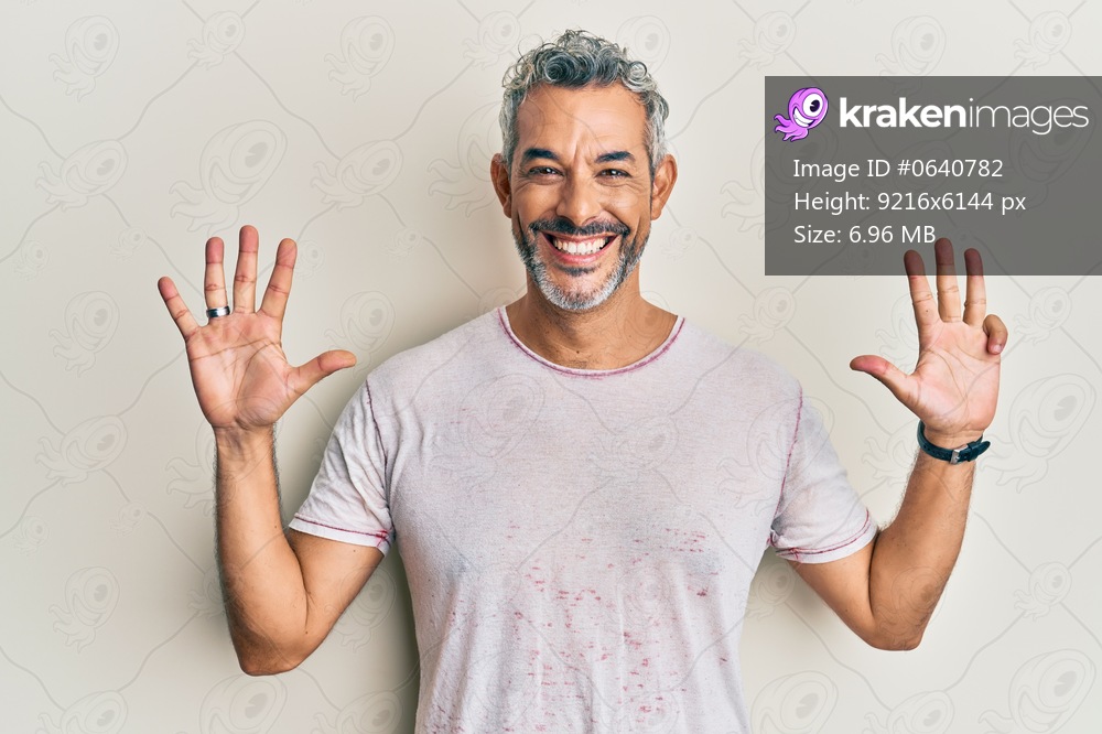 Middle age grey-haired man wearing casual clothes showing and pointing up with fingers number nine while smiling confident and happy. 