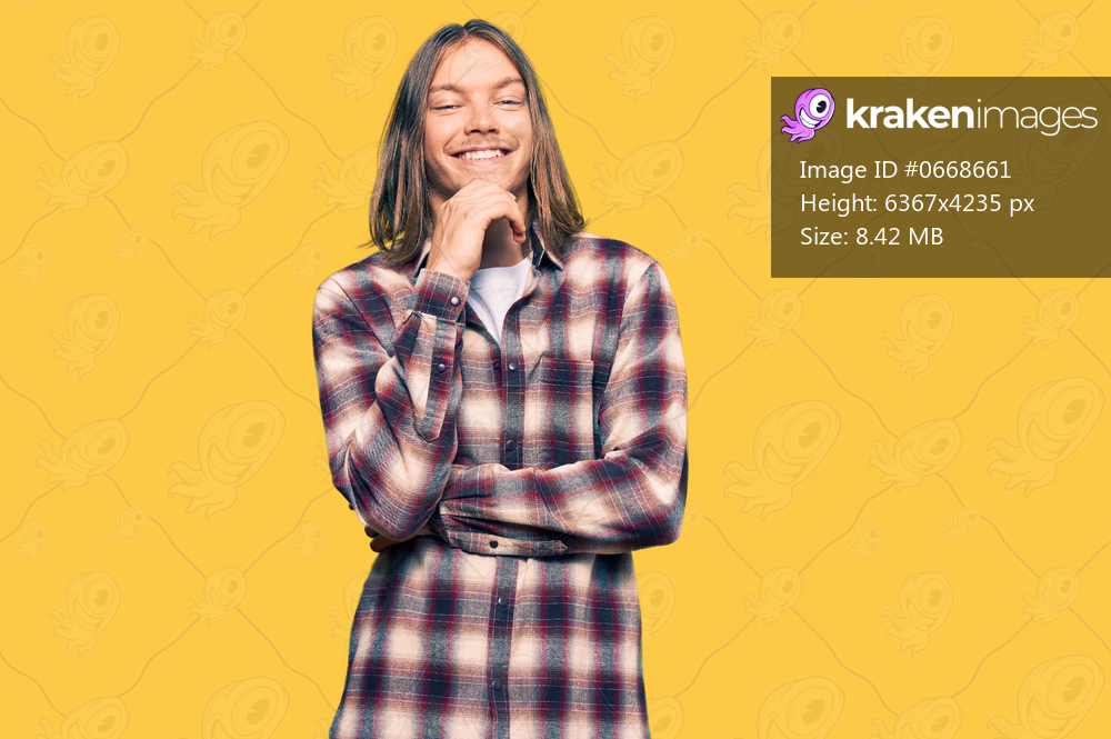 Handsome caucasian man with long hair wearing hipster shirt looking confident at the camera with smile with crossed arms and hand raised on chin. thinking positive. 