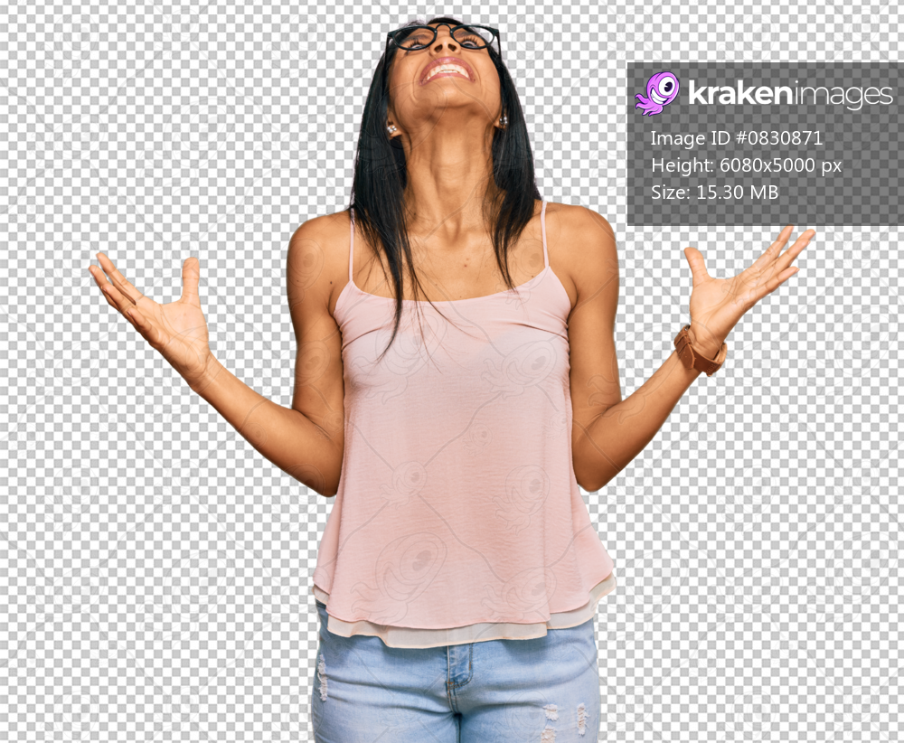 Young african american woman wearing casual clothes and glasses crazy and mad shouting and yelling with aggressive expression and arms raised. frustration concept.