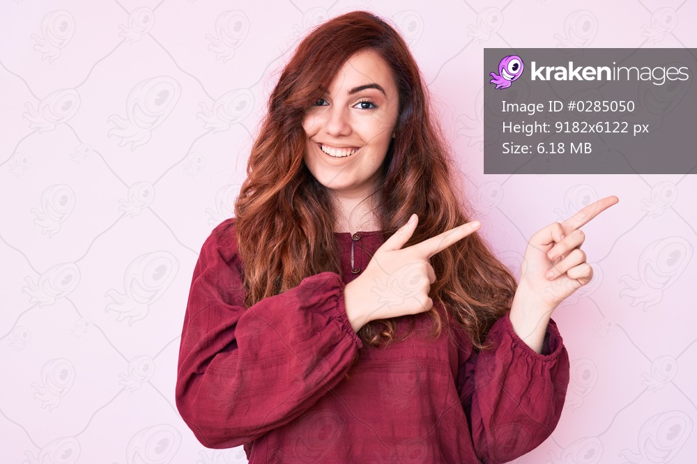 Young beautiful woman wearing casual winter sweater smiling and looking at the camera pointing with two hands and fingers to the side. 