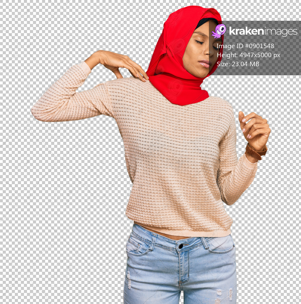 Young african american woman wearing traditional islamic hijab scarf suffering of neck ache injury, touching neck with hand, muscular pain