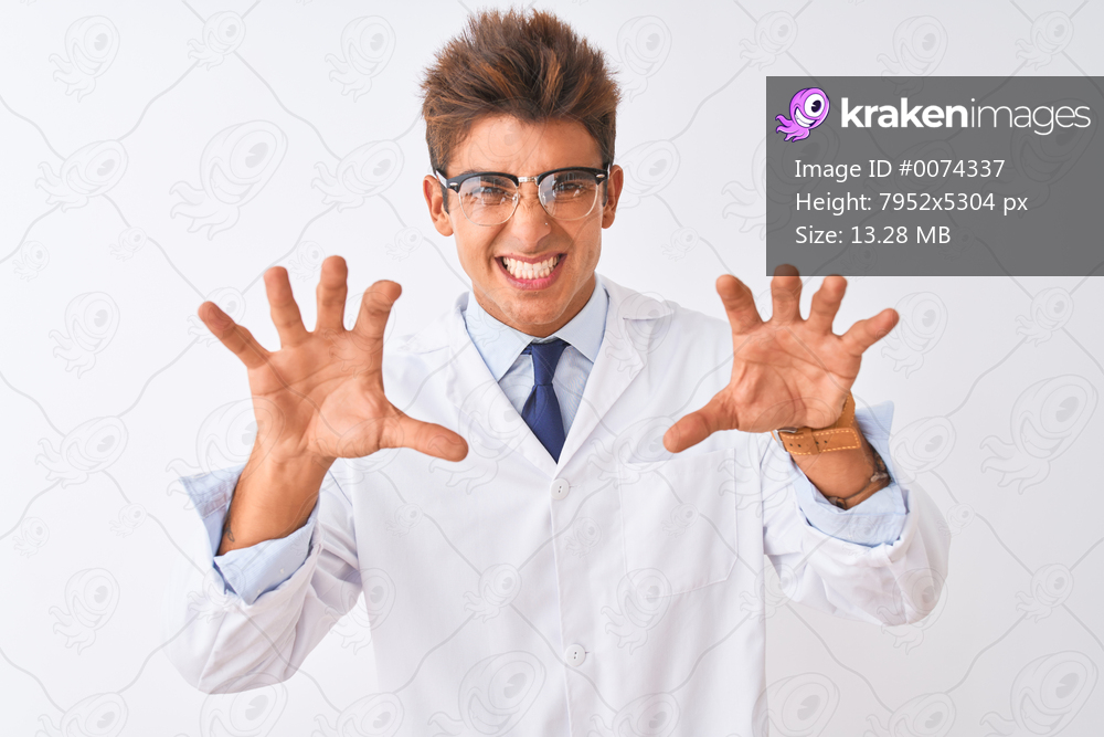 Young handsome sciencist man wearing glasses and coat over isolated white background smiling funny doing claw gesture as cat, aggressive and sexy expression