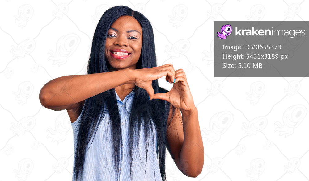 Young african american woman wearing casual clothes smiling in love doing heart symbol shape with hands. romantic concept. 