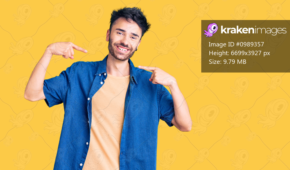 Young hispanic man wearing casual clothes smiling cheerful showing and pointing with fingers teeth and mouth. dental health concept. 