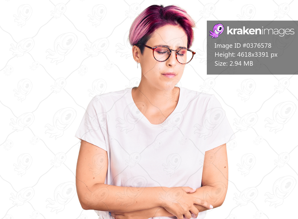 Young beautiful woman with pink hair wearing casual clothes and glasses with hand on stomach because indigestion, painful illness feeling unwell. ache concept. 
