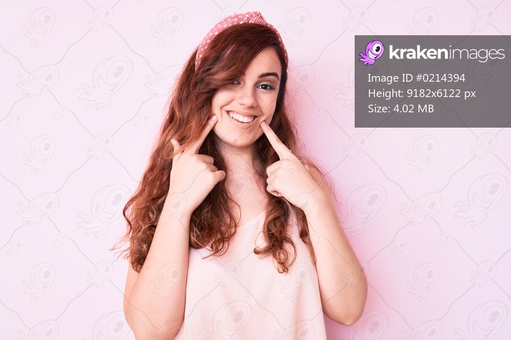 Young beautiful woman wearing casual clothes smiling with open mouth, fingers pointing and forcing cheerful smile 