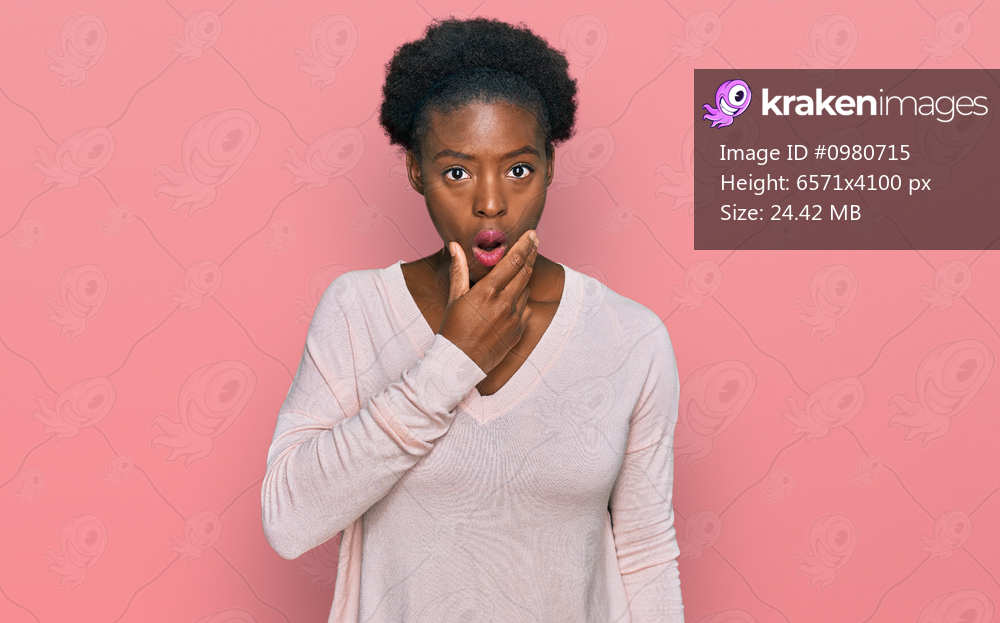 Young african american girl wearing casual clothes looking fascinated with disbelief, surprise and amazed expression with hands on chin 