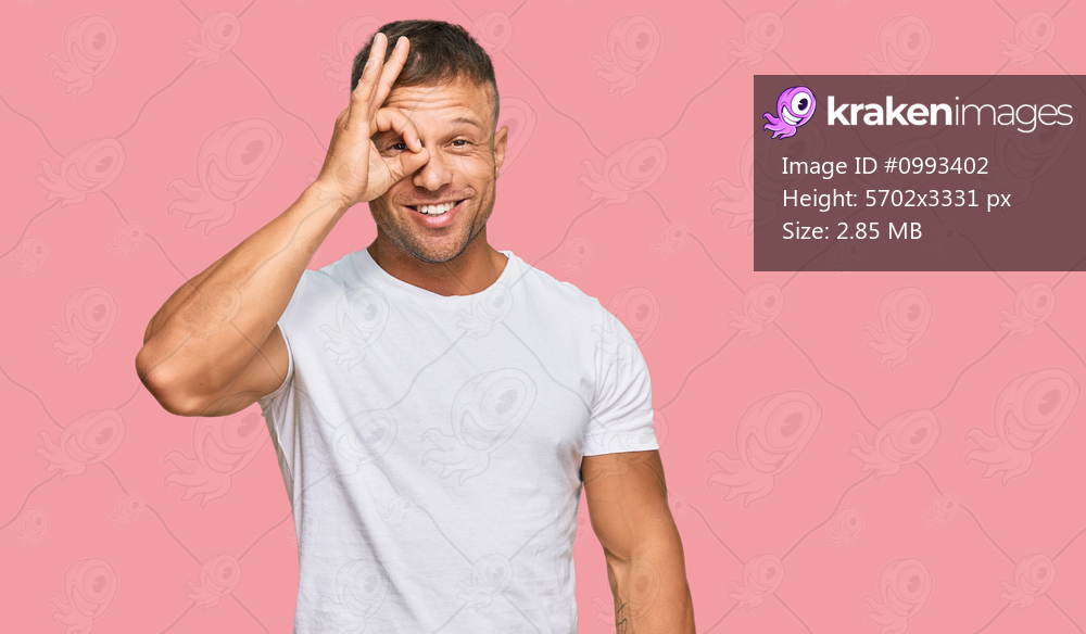 Handsome muscle man wearing casual white tshirt doing ok gesture with hand smiling, eye looking through fingers with happy face. 