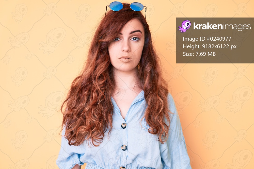 Young beautiful woman wearing casual clothes and sunglasses with serious expression on face. simple and natural looking at the camera. 