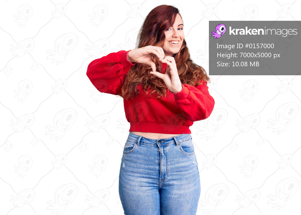 Young beautiful woman wearing casual winter sweater smiling in love doing heart symbol shape with hands. romantic concept. 