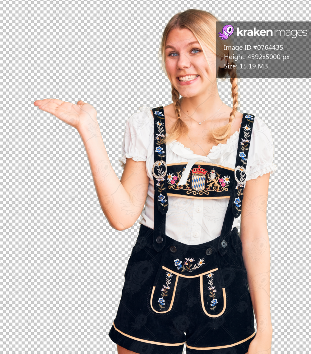 Young beautiful blonde woman wearing oktoberfest dress smiling cheerful presenting and pointing with palm of hand looking at the camera.