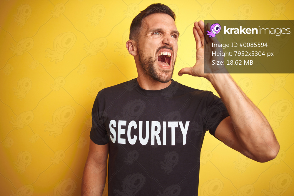 Young safeguard man wearing security uniform over yellow isolated background shouting and screaming loud to side with hand on mouth. Communication concept.