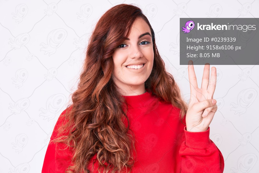 Young beautiful woman wearing casual clothes showing and pointing up with fingers number three while smiling confident and happy. 