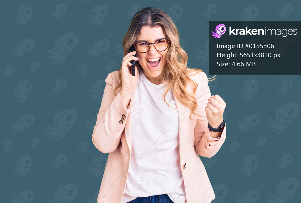 Young caucasian woman having conversation talking on the smartphone screaming proud, celebrating victory and success very excited with raised arms 