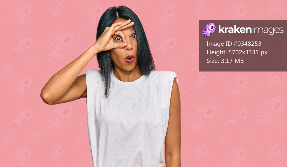 Young african american woman wearing casual clothes doing ok gesture shocked with surprised face, eye looking through fingers. unbelieving expression. 