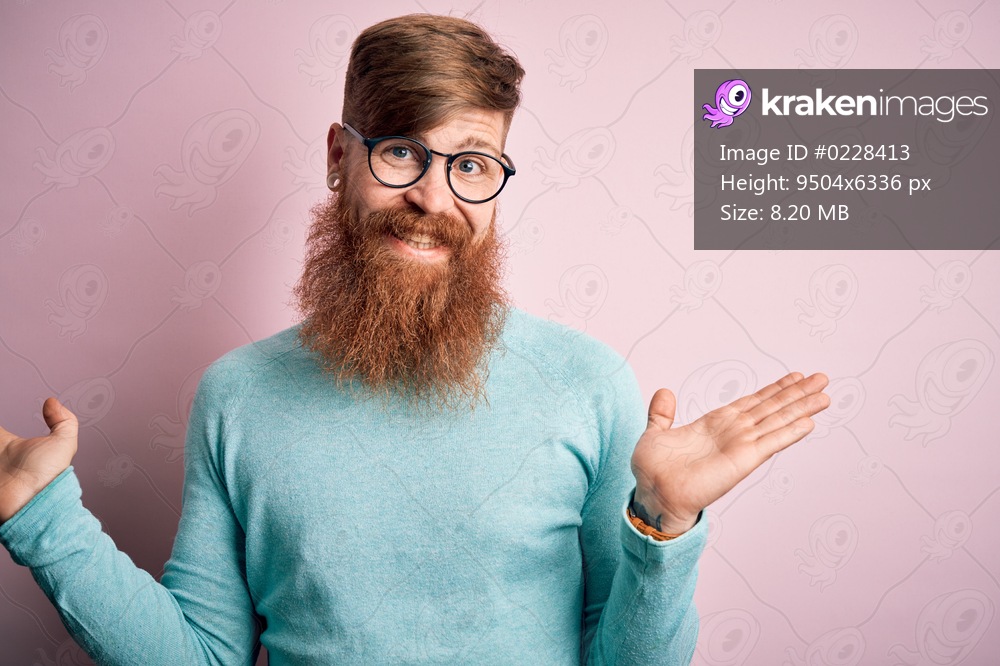 Handsome Irish redhead man with beard wearing glasses over pink isolated background smiling showing both hands open palms, presenting and advertising comparison and balance