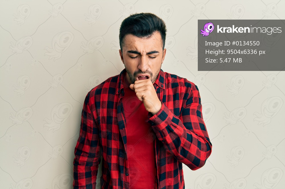 Young hispanic man wearing casual clothes feeling unwell and coughing as symptom for cold or bronchitis. health care concept. 