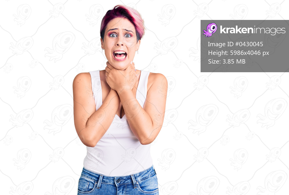 Young beautiful woman with pink hair wearing casual clothes shouting and suffocate because painful strangle. health problem. asphyxiate and suicide concept. 