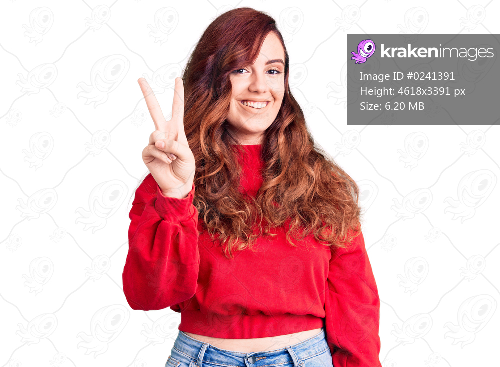 Young beautiful woman wearing casual winter sweater showing and pointing up with fingers number two while smiling confident and happy. 