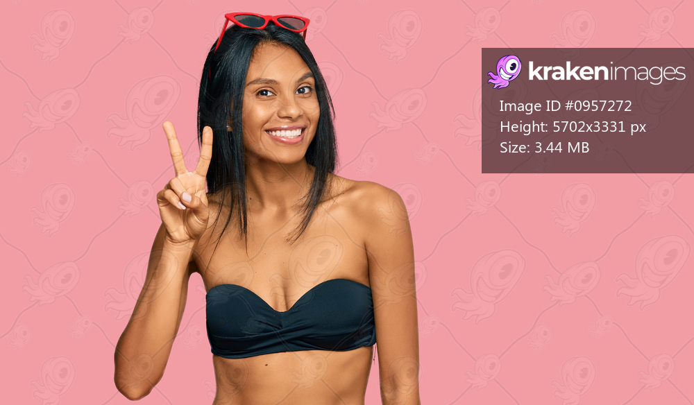 Young african american woman wearing bikini showing and pointing up with fingers number two while smiling confident and happy. 