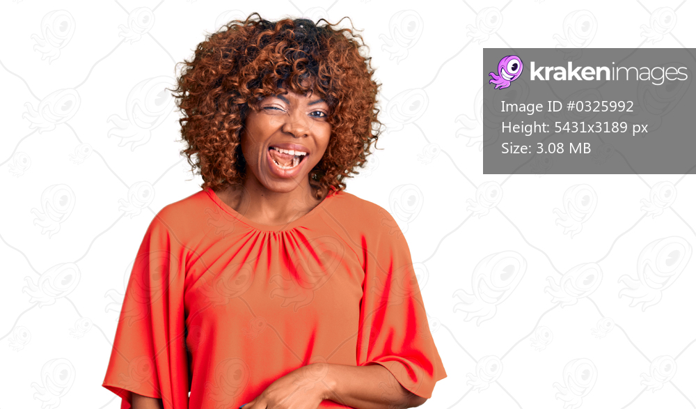 Young african american woman wearing casual clothes winking looking at the camera with sexy expression, cheerful and happy face. 