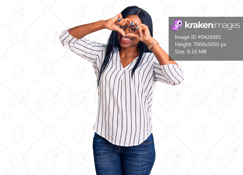 Young african american woman wearing casual clothes and glasses doing heart shape with hand and fingers smiling looking through sign 