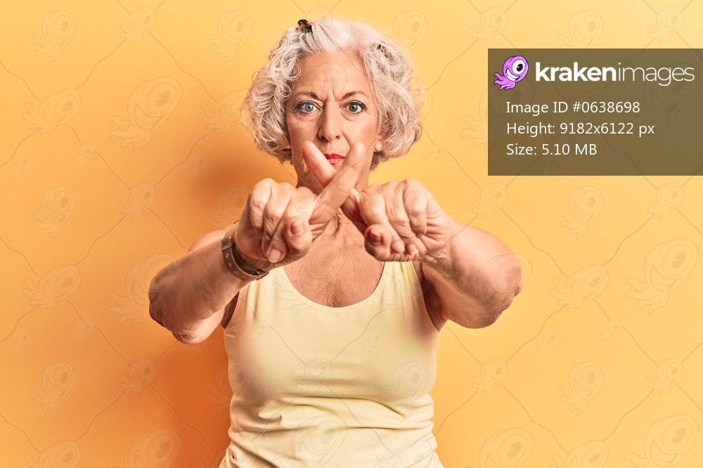 Senior grey-haired woman wearing casual clothes rejection expression crossing fingers doing negative sign 