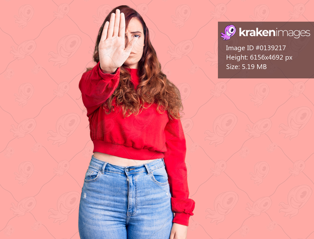 Young beautiful woman wearing casual winter sweater doing stop sing with palm of the hand. warning expression with negative and serious gesture on the face. 